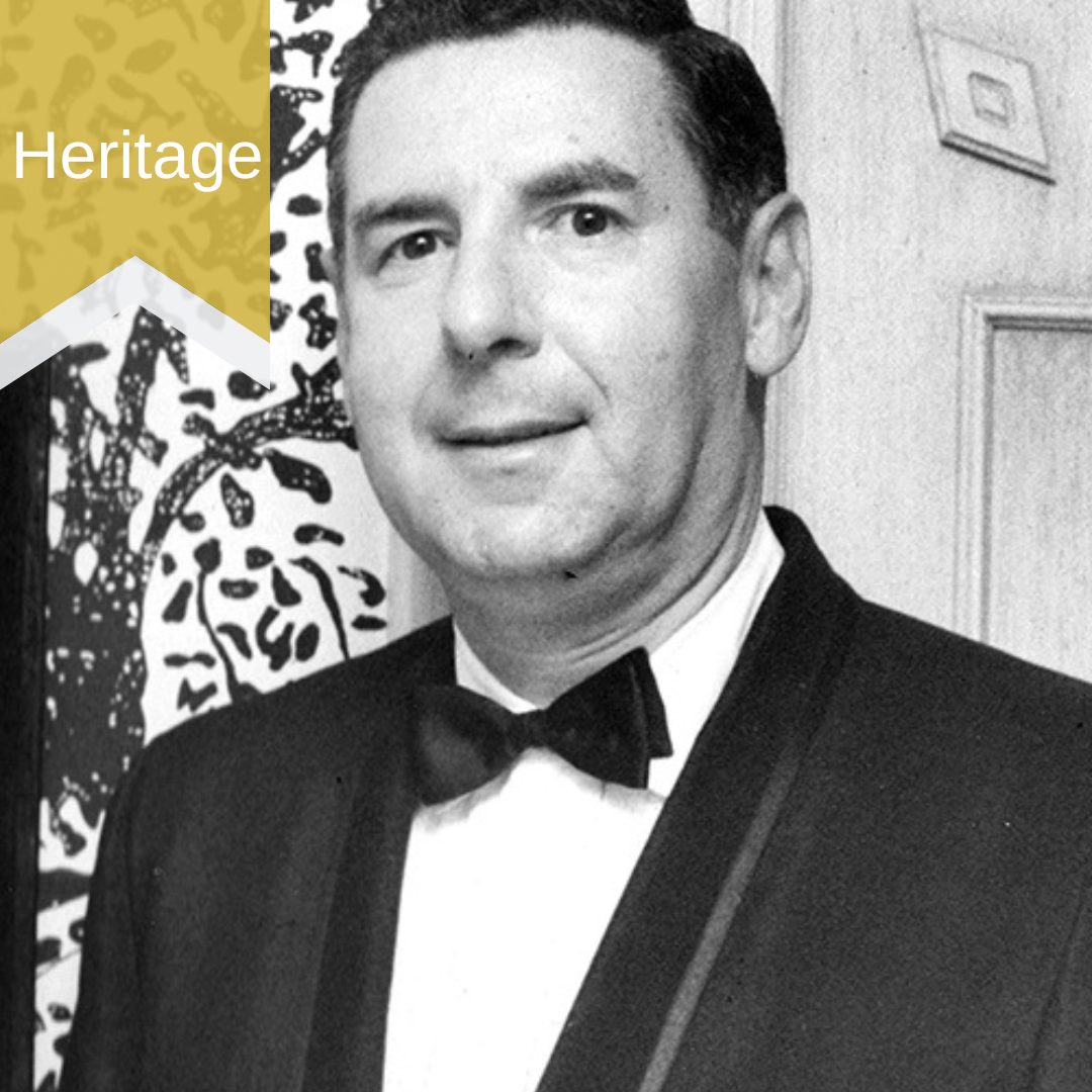 Black and white photo of a man in a tuxedo.