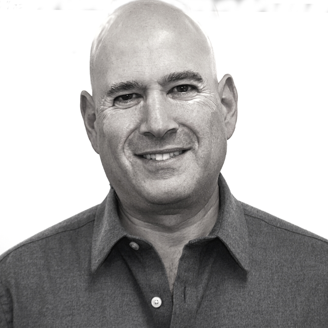 Portrait of a smiling bald man in a dark shirt.