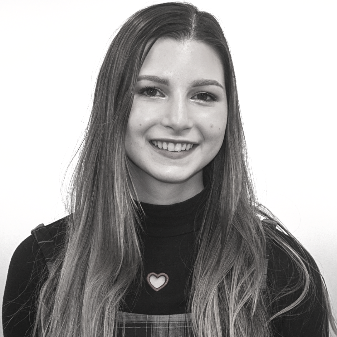 A young woman with long hair smiling at the camera.