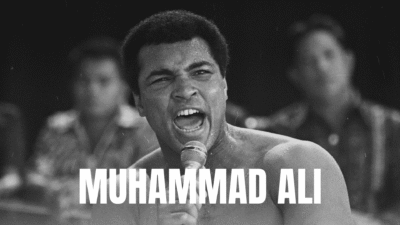 Black and white image of a Muhammad Ali shouting passionately.