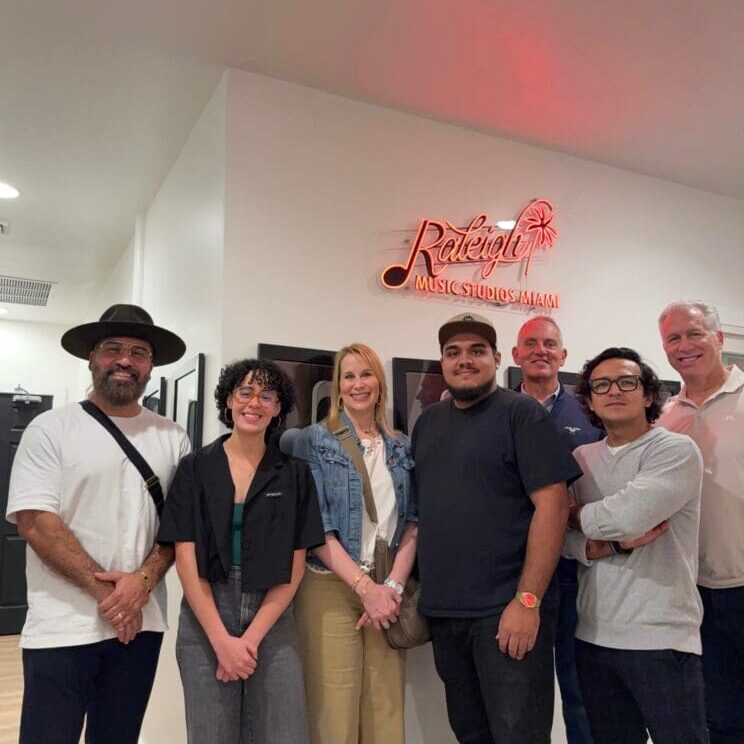 Group of people standing in a room.